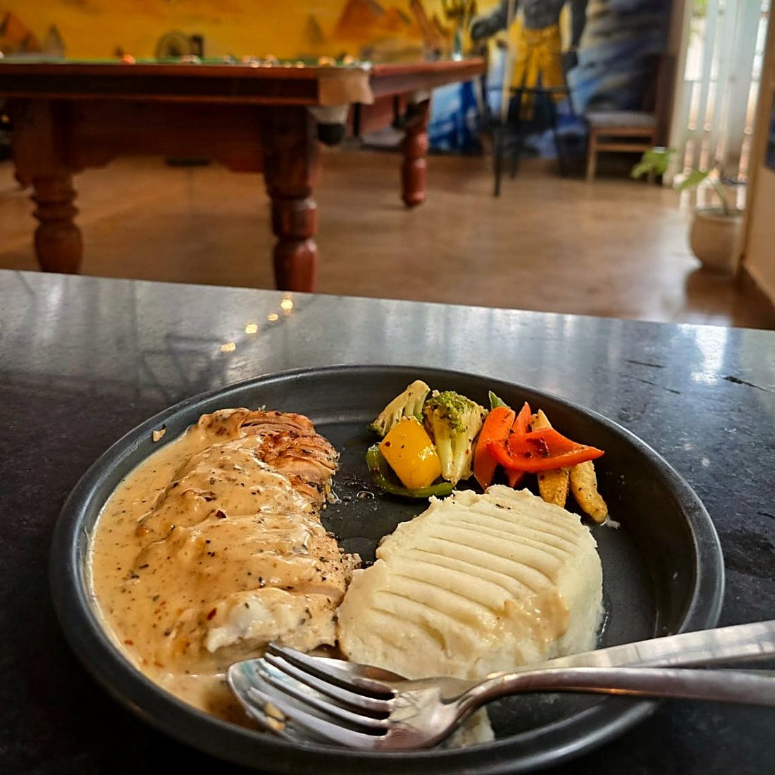 Grilled chicken steak with mash and vegetables
