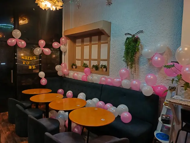 Pink balloon setup indoors, SB Road